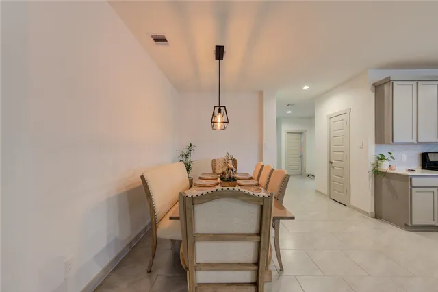 a dining room with furniture and wooden floor