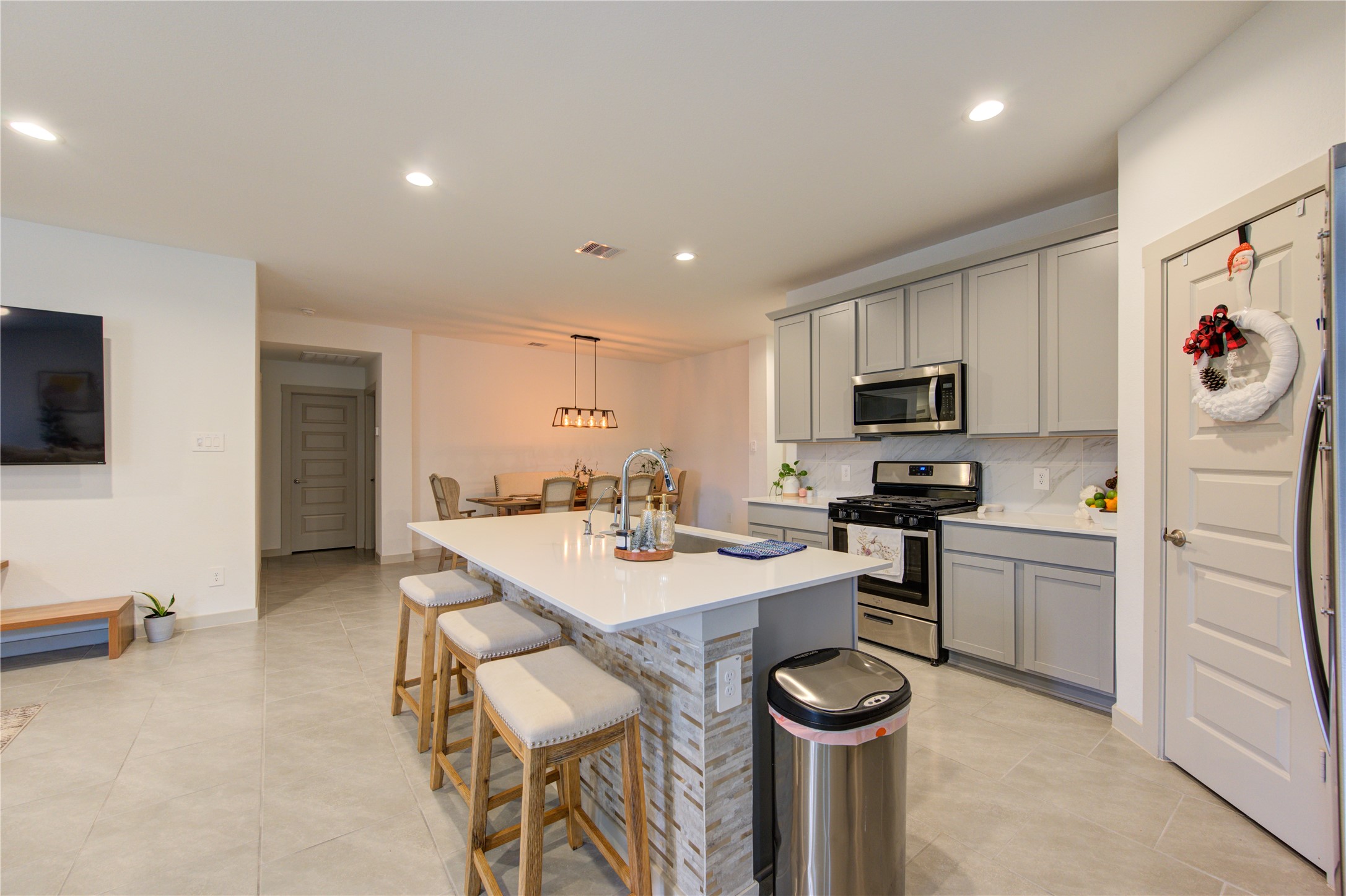 29522 Cayenne Circle Katy, TX 77494 - Photo 27 of 46 a kitchen with a sink a stove cabinets and refrigerator