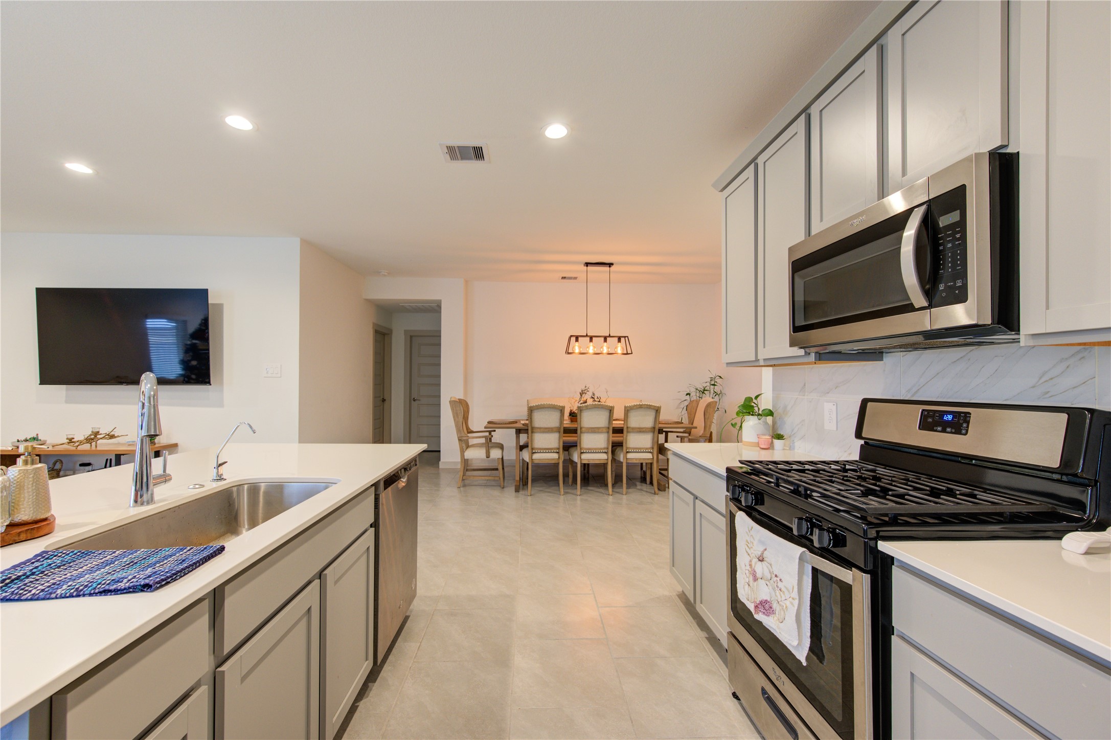29522 Cayenne Circle Katy, TX 77494 - Photo 28 of 46 a kitchen with stainless steel appliances a stove sink microwave and cabinets