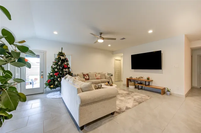 a living room with furniture and a flat screen tv