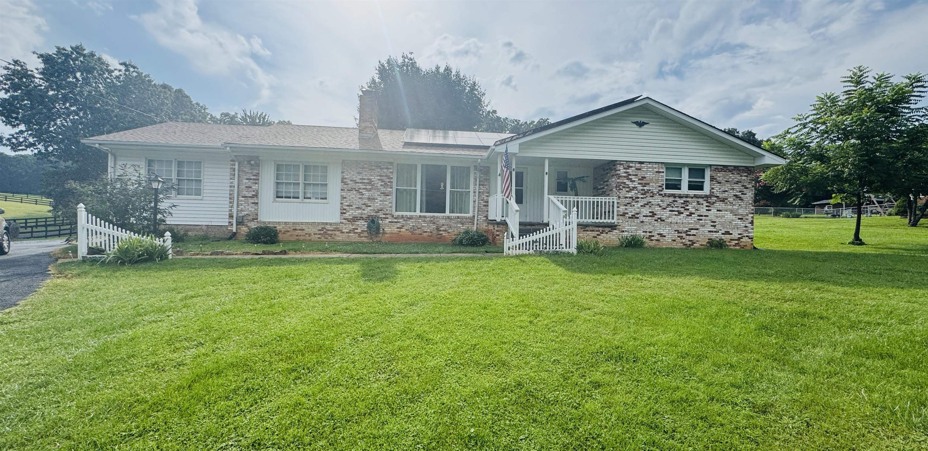 2228 Shutterlee Mill Road Staunton, VA 24401 - Photo 1 of 1 a front view of a house with a garden and deck