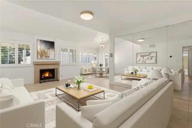 a living room with furniture a fireplace and a table