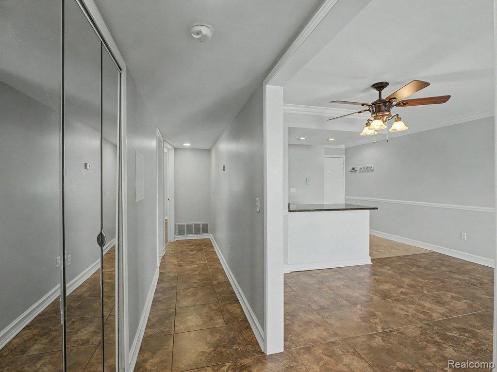 1974 Klingensmith Road, Unit 4 Bloomfield Hills, MI 48302 - Photo 12 of 35 Hallway entry featuring mirrored closet doors, recessed lighting, and tile flooring