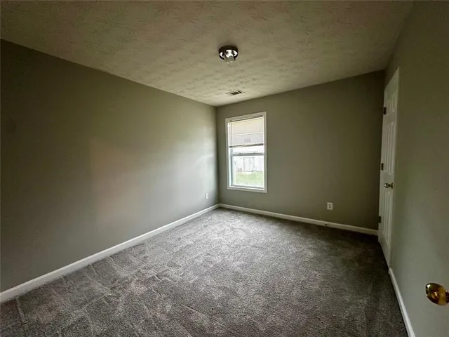 wooden floor and window in an empty room
