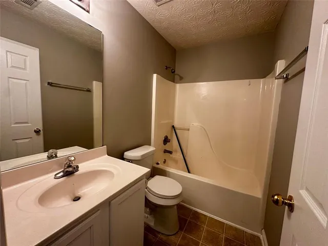 a bathroom with a sink toilet and a mirror