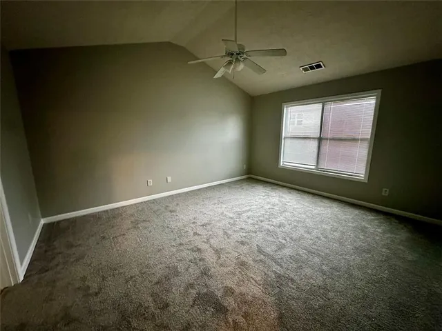 an empty room with a empty space and windows