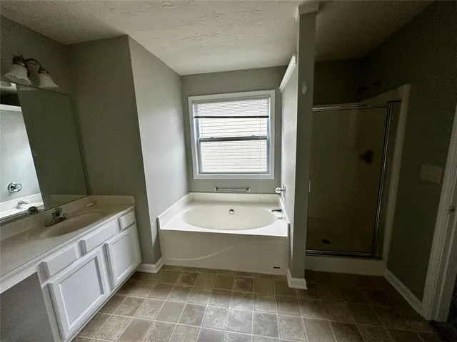 a bathroom with a bathtub sink and mirror