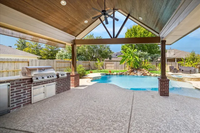 a kitchen with stainless steel appliances granite countertop a stove a sink and a wooden floors
