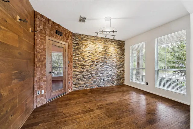 wooden floor in an empty room with a fireplace