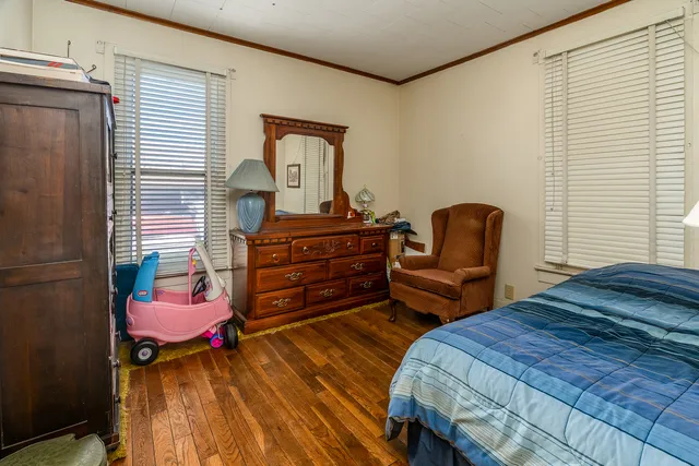 a bedroom with a bed and chair