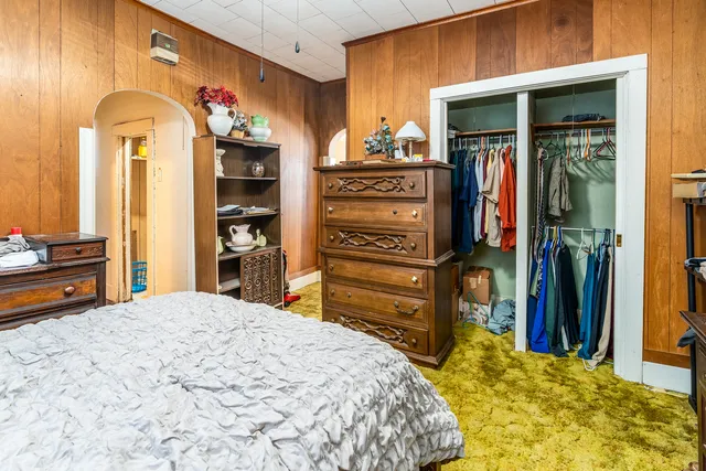 a bedroom with a bed and a television