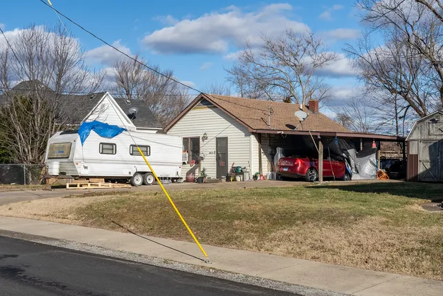 a view of a house with a yard and garage