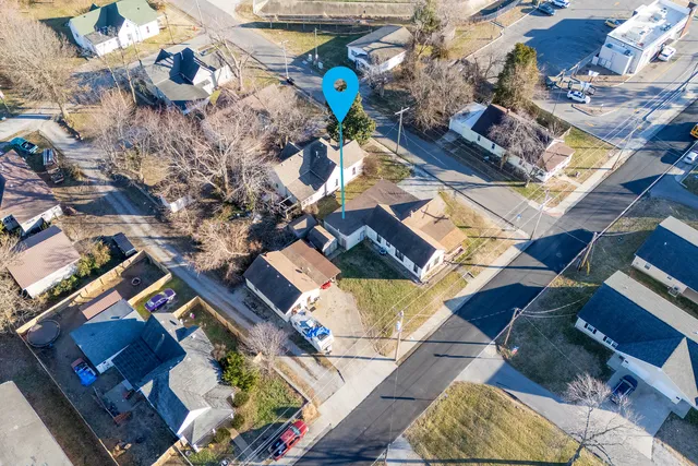 an aerial view of a house with a yard and wooden floor