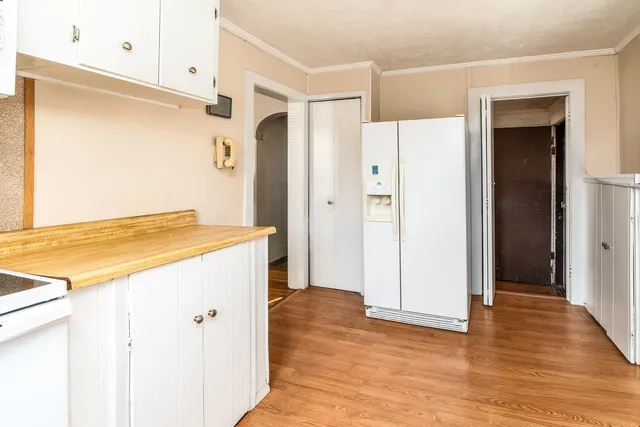 a view of kitchen with stainless steel appliances wooden floor