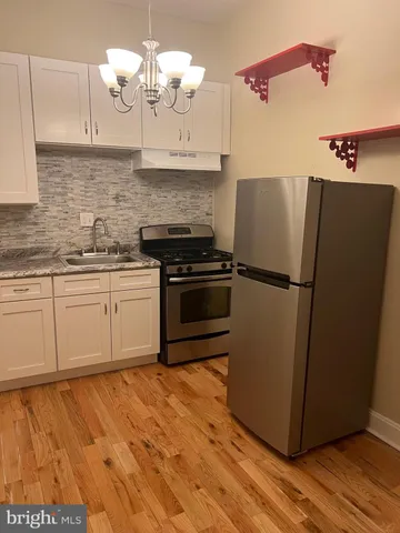 a view of room with window and wooden floor