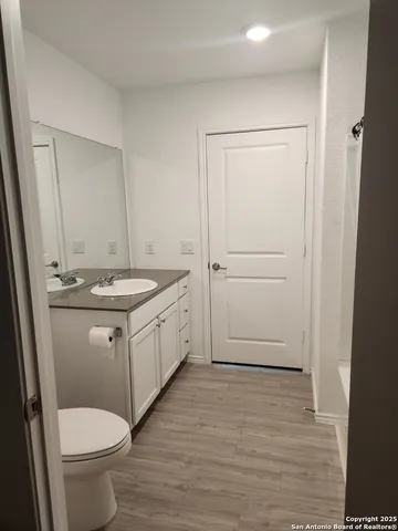 a bathroom with a sink toilet and vanity