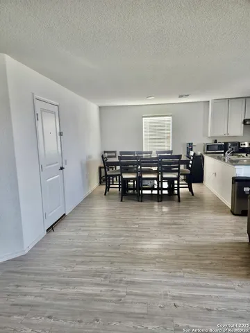 a view of a room with furniture wooden floor and window