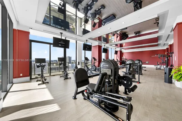 a view of a gym with gym equipment