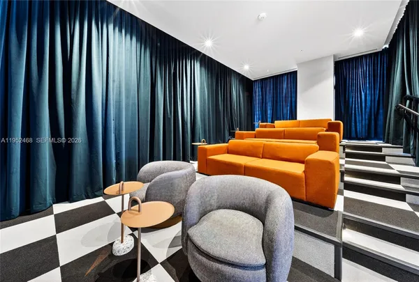 a blue room with a couch and a chair