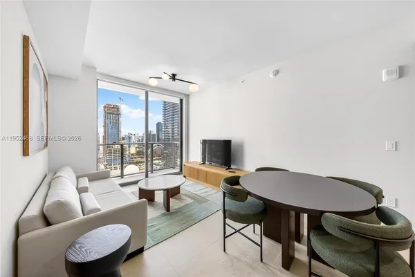 a living room with furniture and a large window