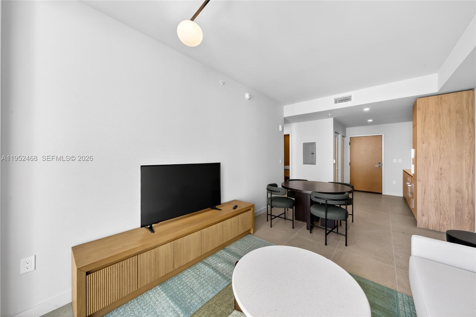 11 Northeast 6th Street, Unit 3210 Miami, FL 33132 - Photo 6 of 34 a living room with furniture and a flat screen tv