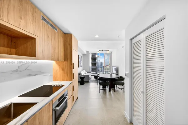 a kitchen with stainless steel appliances kitchen island furniture and a window