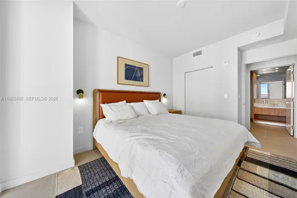 a bedroom with a bed and a night stand