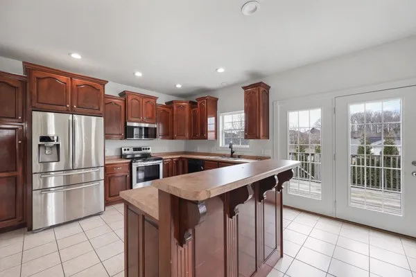 a kitchen with stainless steel appliances granite countertop a refrigerator sink and cabinets