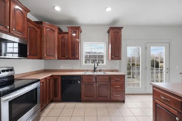 a kitchen with stainless steel appliances granite countertop a refrigerator sink and stove