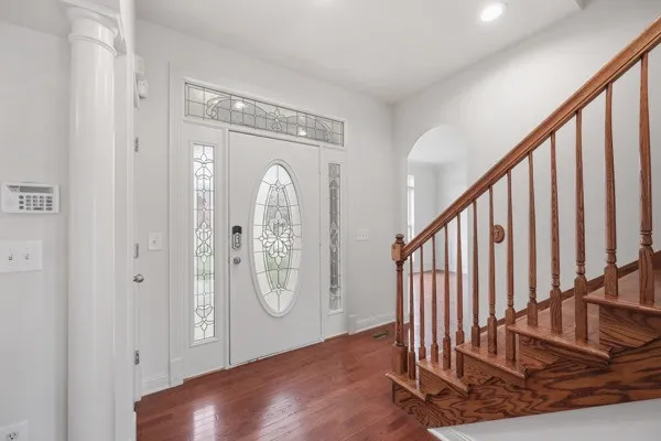 a view of an entryway with wooden floor and a floor to ceiling window