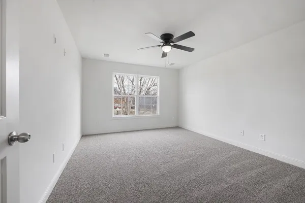 a view of a room with a ceiling fan
