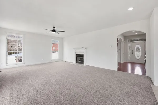 a view of a livingroom with a fireplace and a ceiling fan