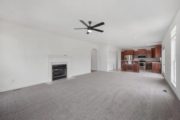 a view of empty room with furniture and window