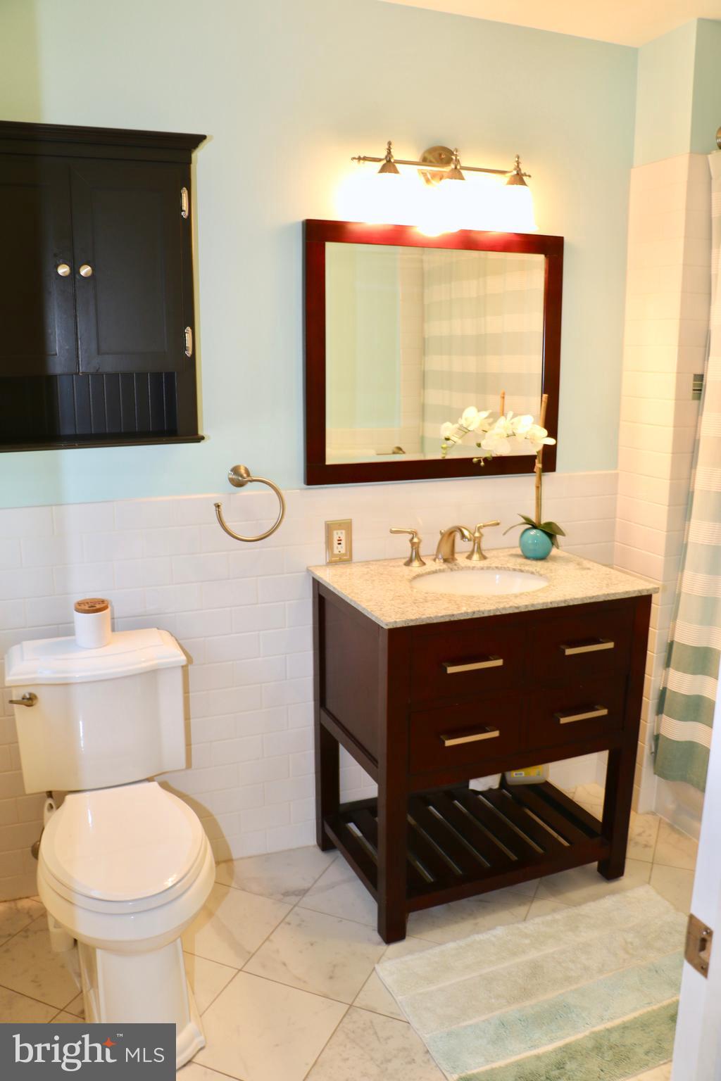2307 Silverside Road Wilmington, DE 19810 - Photo 18 of 40 a bathroom with a toilet sink and mirror