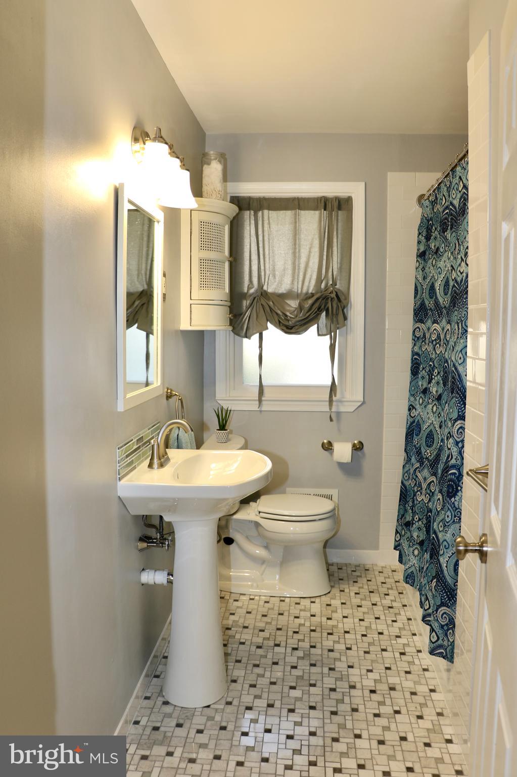 2307 Silverside Road Wilmington, DE 19810 - Photo 21 of 40 a bathroom with a sink toilet and shower