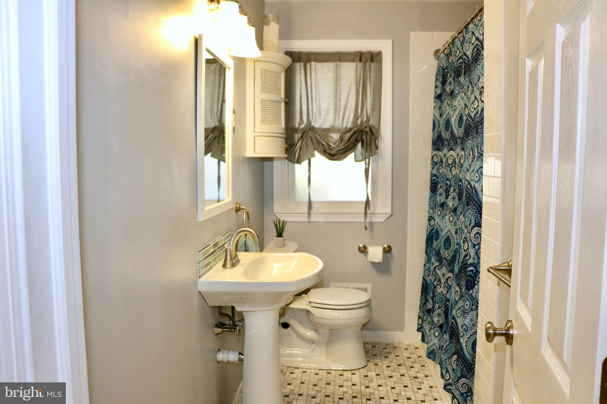 2307 Silverside Road Wilmington, DE 19810 - Photo 22 of 40 a bathroom with a sink toilet and shower