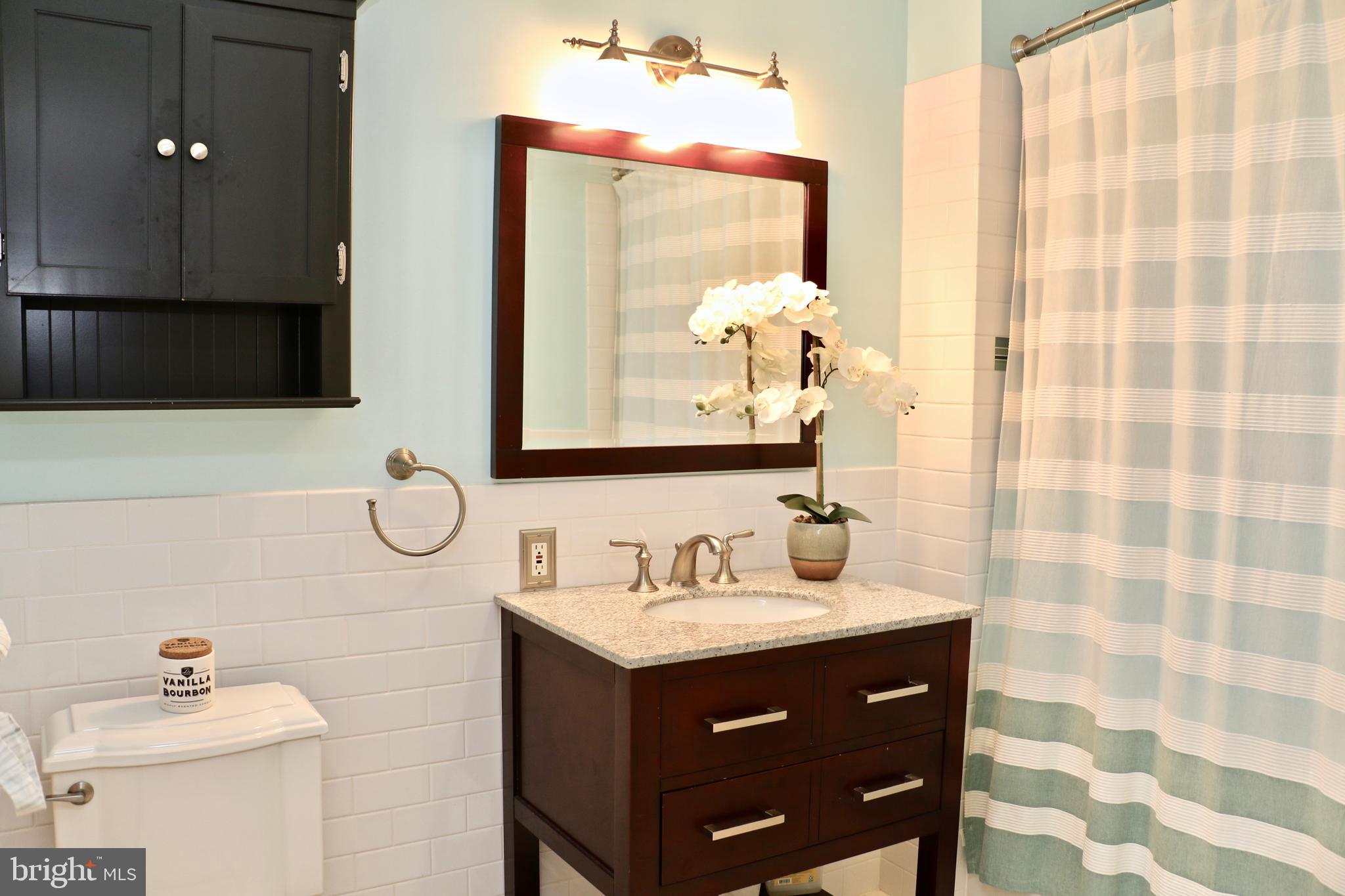 2307 Silverside Road Wilmington, DE 19810 - Photo 35 of 40 a bathroom with a sink vanity and a mirror