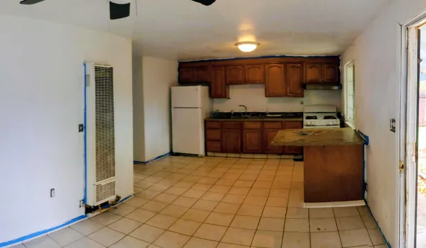 a kitchen with stainless steel appliances granite countertop a refrigerator and a stove