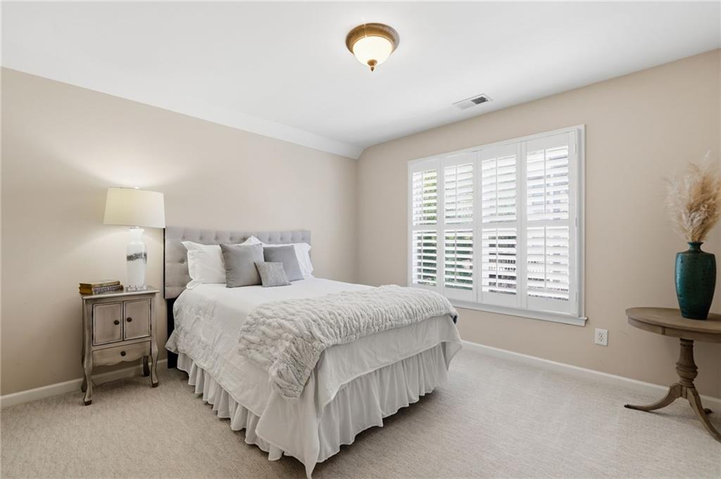 4147 Gold Mill Ridge Canton, GA 30114 - Photo 42 of 93 a bedroom with a bed and a tv on the dresser