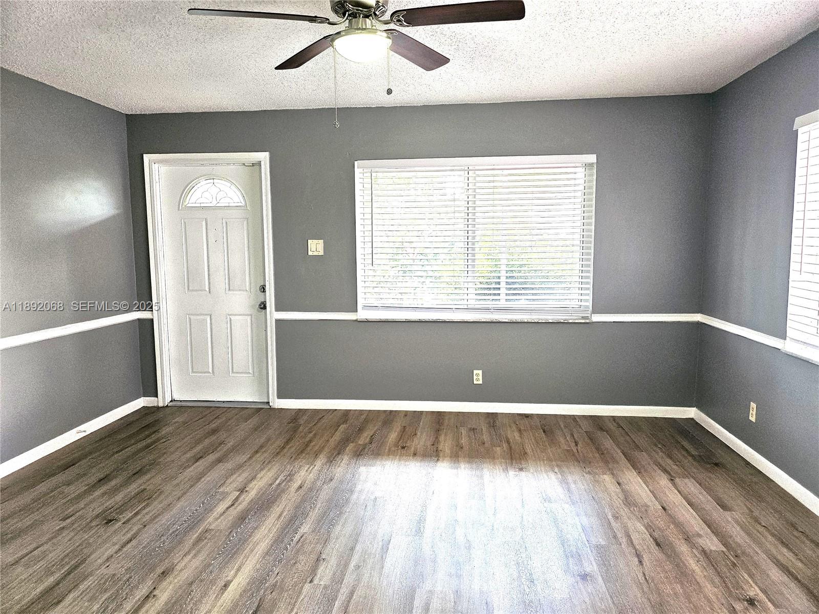 1040 Northwest 73rd Terrace Margate, FL 33063 - Photo 14 of 41 an empty room with wooden floor and windows