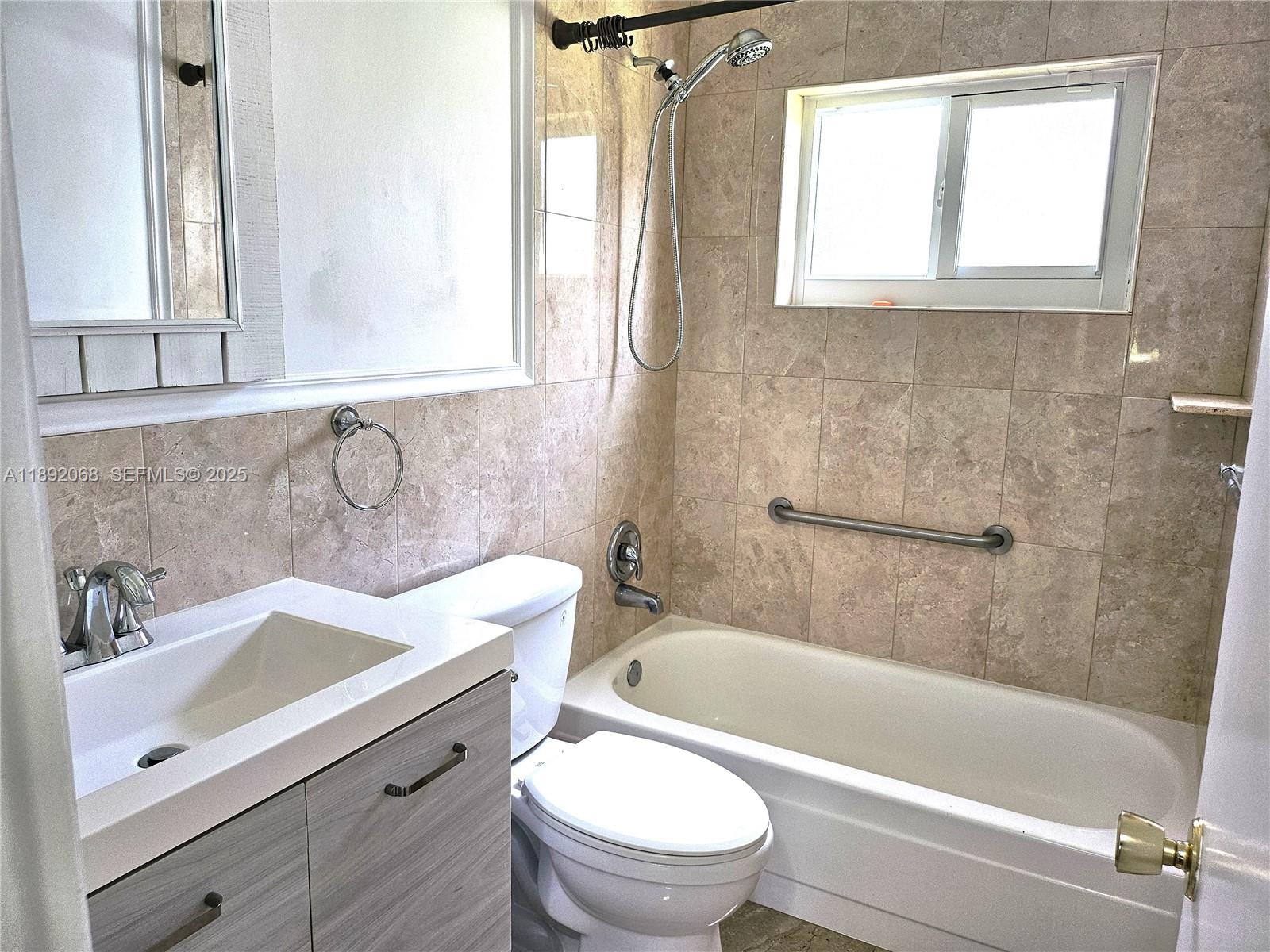 1040 Northwest 73rd Terrace Margate, FL 33063 - Photo 15 of 41 a bathroom with a sink a toilet and a bathtub