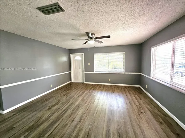 a view of room with window and ceiling fan