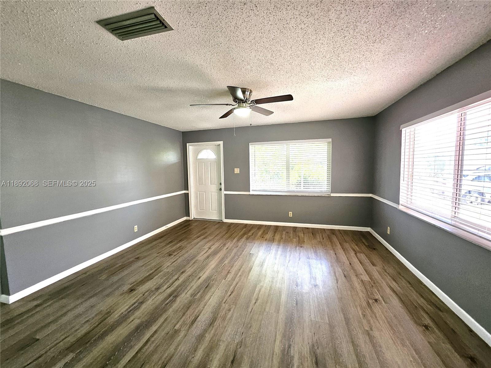 1040 Northwest 73rd Terrace Margate, FL 33063 - Photo 19 of 41 wooden floor in an empty room with a window