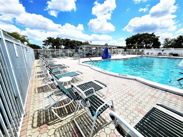 a view of a backyard with sitting area