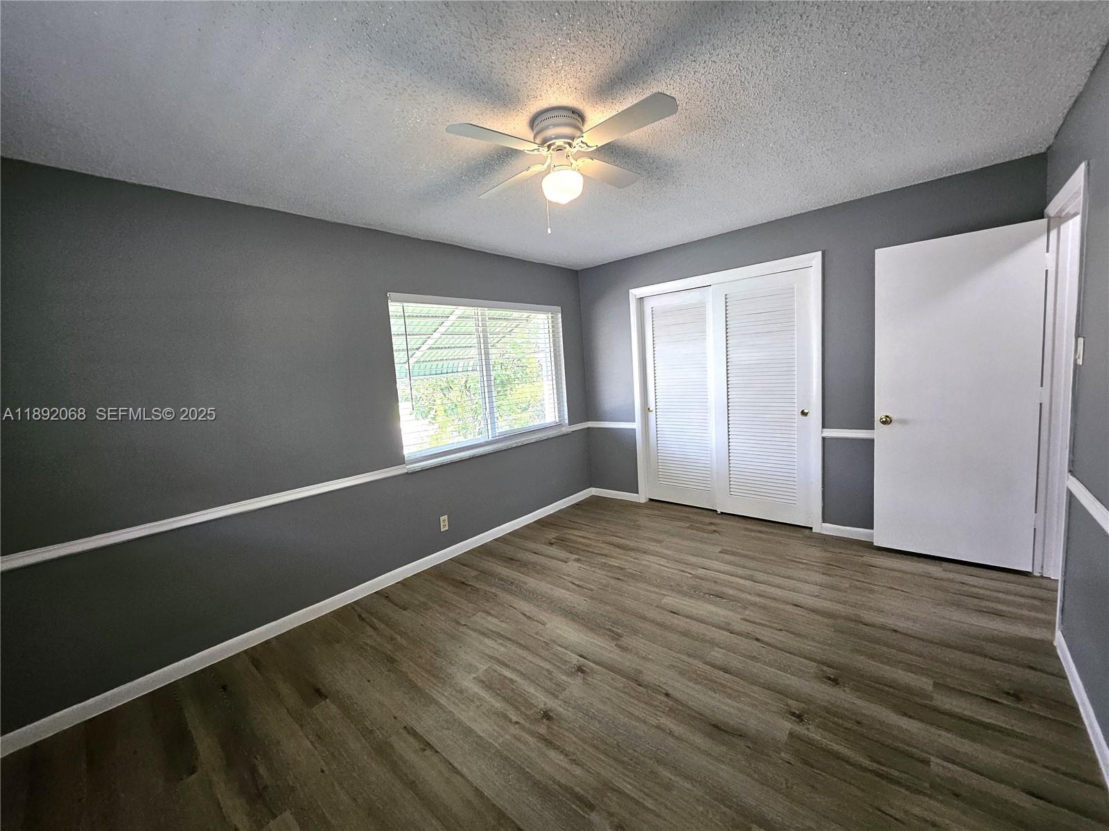 1040 Northwest 73rd Terrace Margate, FL 33063 - Photo 22 of 41 an empty room with wooden floor and windows
