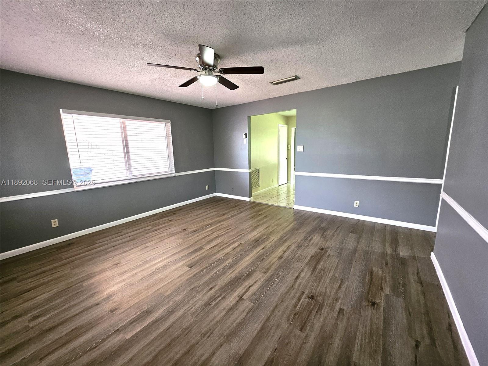 1040 Northwest 73rd Terrace Margate, FL 33063 - Photo 24 of 41 wooden floor in an empty room with a window