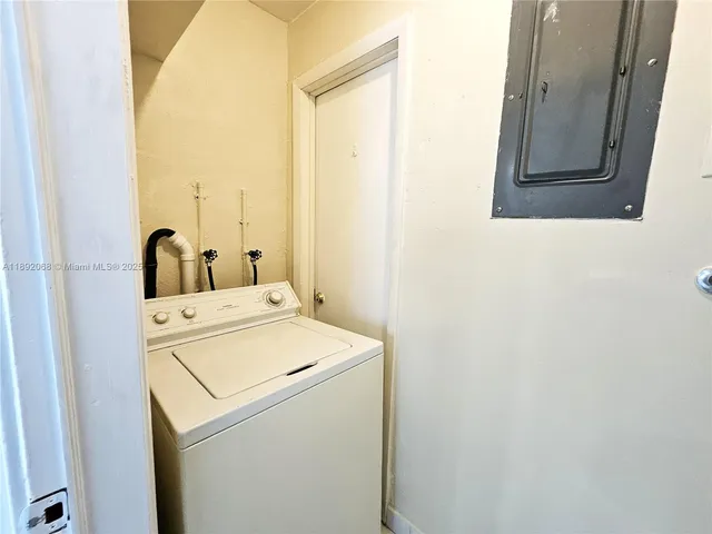 a view of kitchen with sink window and refrigerator