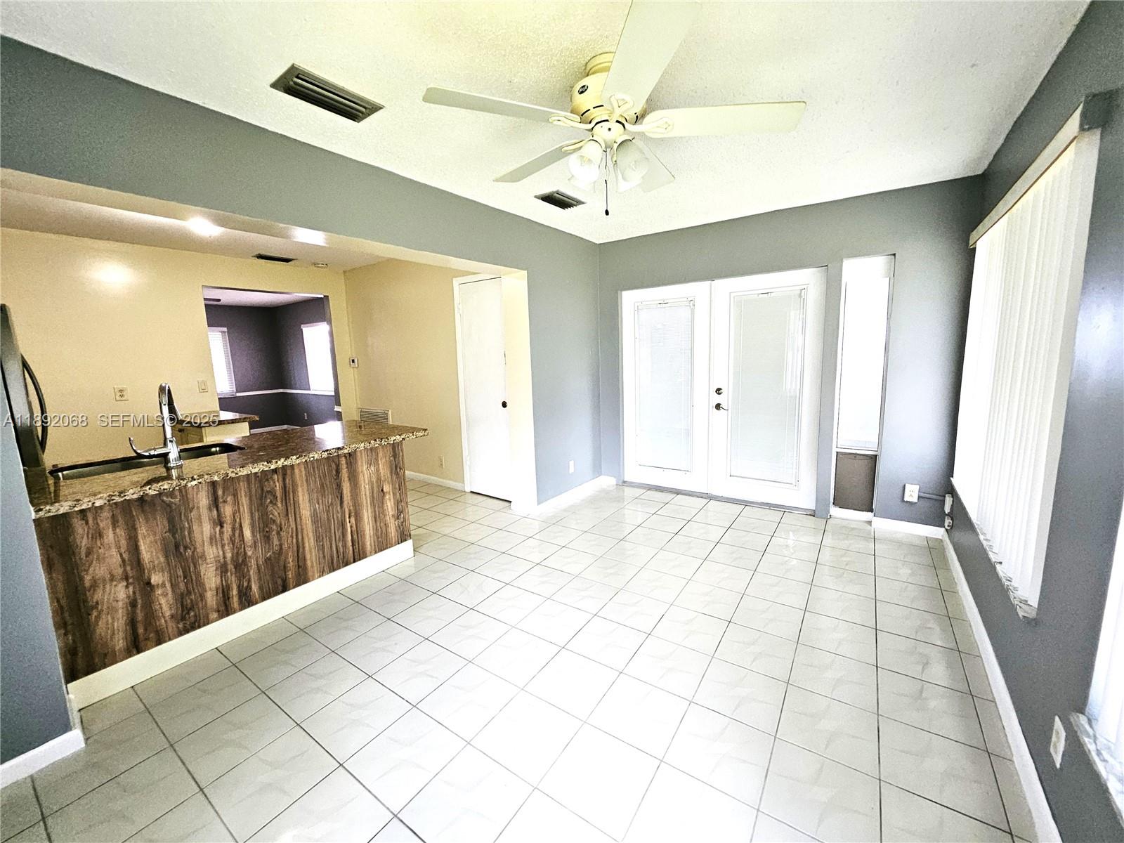 1040 Northwest 73rd Terrace Margate, FL 33063 - Photo 32 of 41 a view of a kitchen with kitchen island granite countertop lots of counter top space and stainless steel appliances