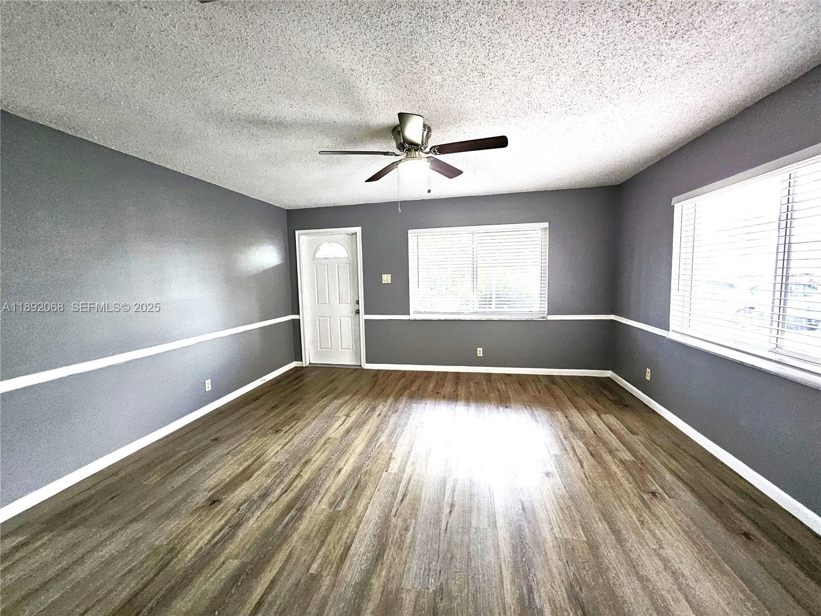1040 Northwest 73rd Terrace Margate, FL 33063 - Photo 34 of 41 wooden floor in an empty room with a window
