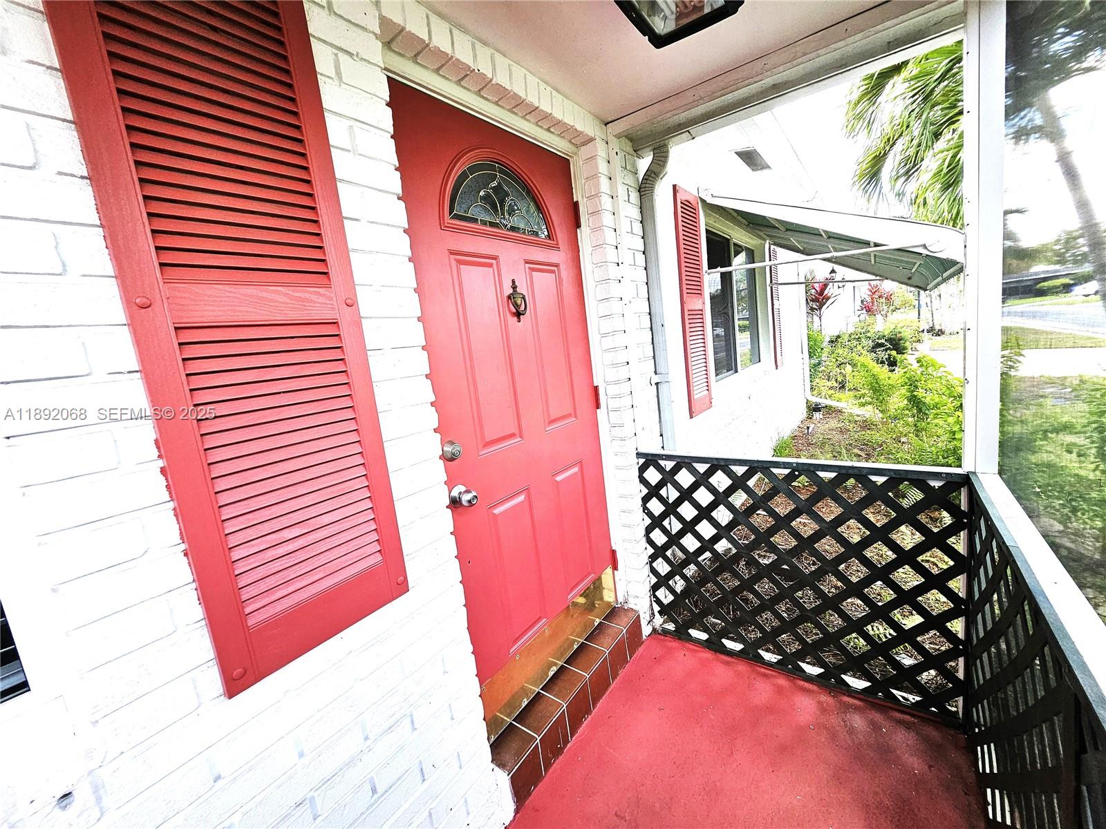 1040 Northwest 73rd Terrace Margate, FL 33063 - Photo 35 of 41 a bedroom with wooden floor and a window